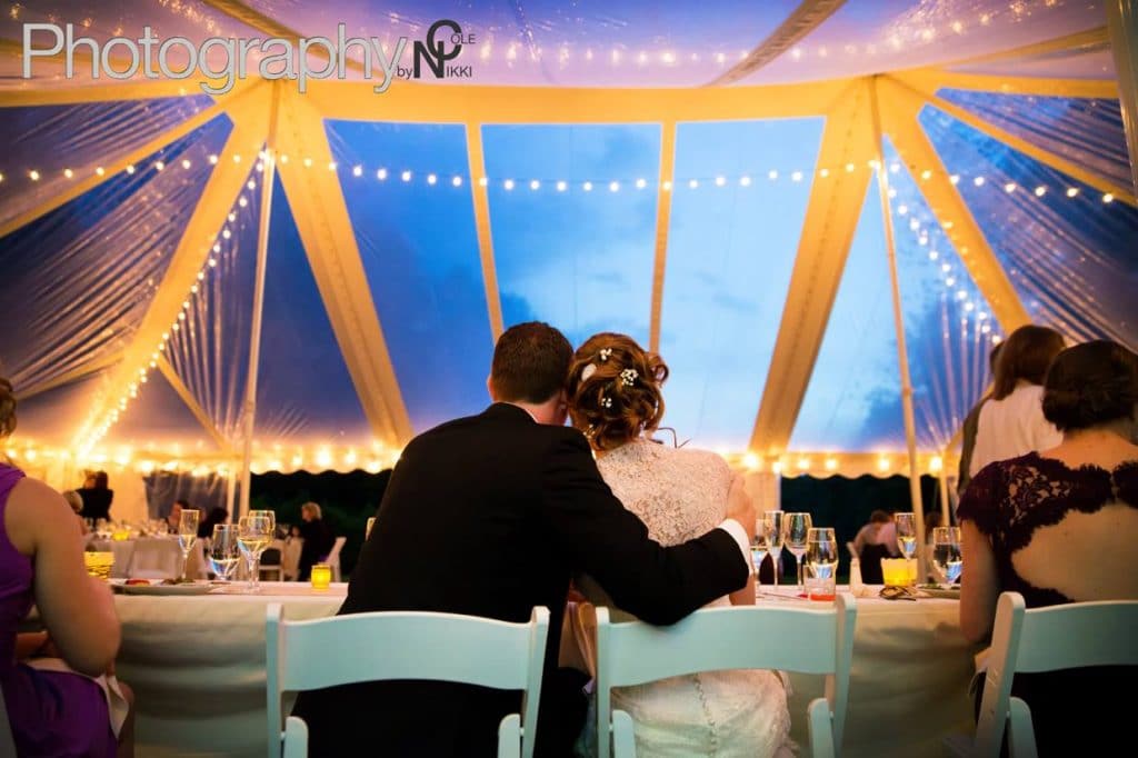Couple embrace in elegant setting, listening to Night Shift Entertainment